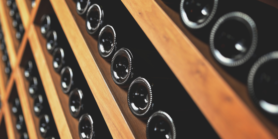 Wooden wine rack with wine bottles stored horizontally