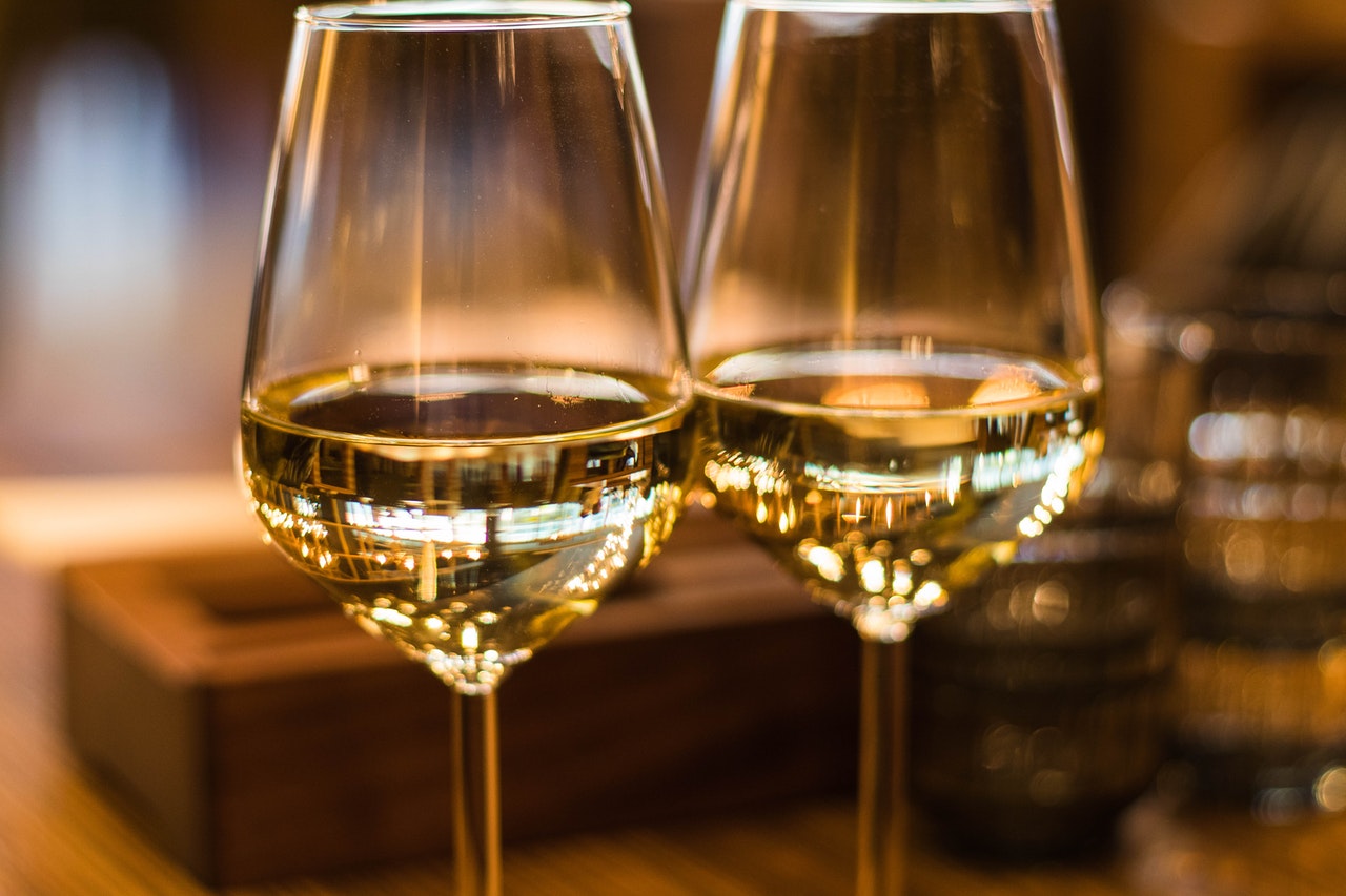 Close up of two wine glasses with white wine