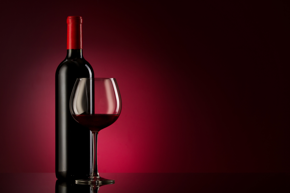 A bottle and glass of red wine