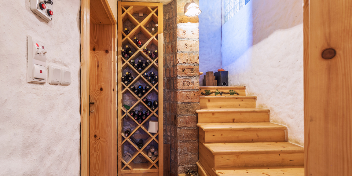Wine cellar by the wall near the staircase
