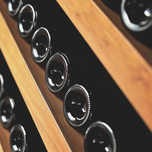 Wooden wine rack with wine bottles stored horizontally