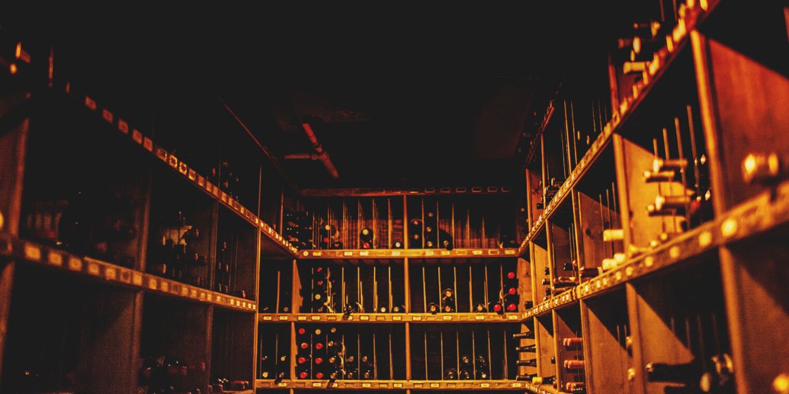 Dim wine cellar with wine bottles on the rack