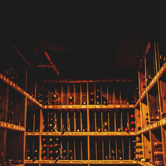 Dim wine cellar with wine bottles on the rack