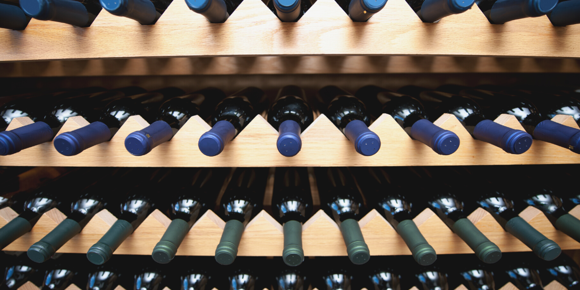 Wooden wine rack lined with wine bottles