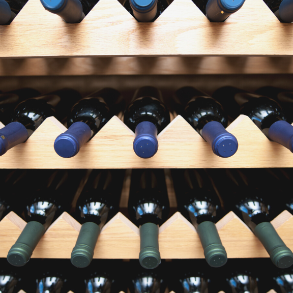 Wooden wine rack lined with wine bottles
