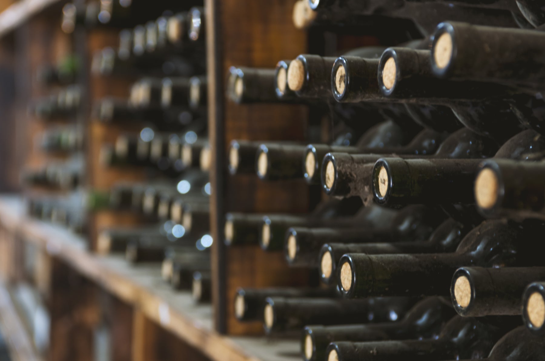 Wine bottles stored on its side in a wine rack